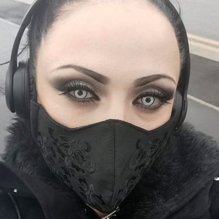 Miss Fortune London modeling the Vampfangs 3 layer cotton face mask. This style is black on black variation and embroidered with a black brocade pattern. Simply stunning.