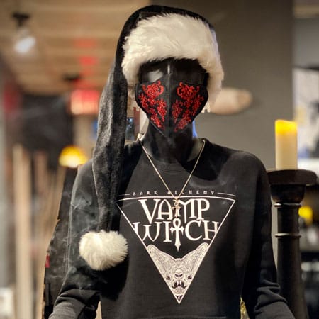 Vampfangs' store mannequin wearing a black santa hat along with a red brocade embroidered face mask and a Dark Alchemy crop crew in the Vamp Witch design.