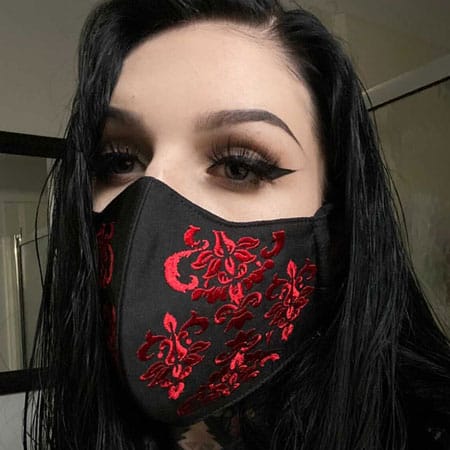 Model Briana Todd wearing a red brocade embroidered cotton face mask. These masks are comfortable and beautiful.