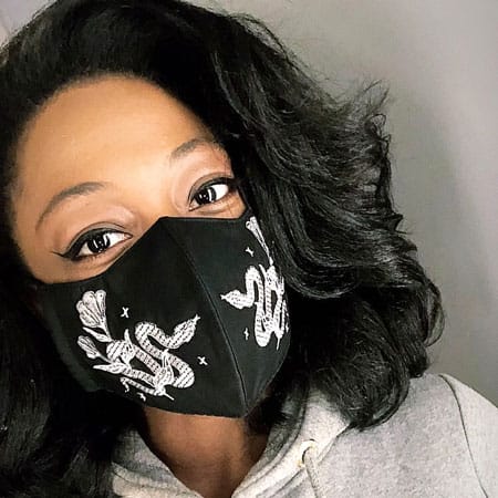 Yani from Massachusetts modeling the Vampfangs 3 layer cotton face mask. This variation is the white embroidered serpent on a black cotton mask. Large design with great coverage and detail.